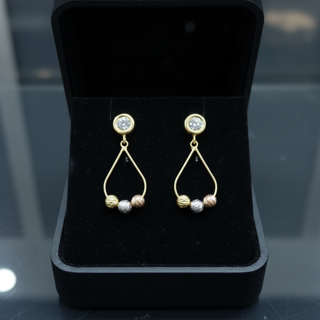 Aretes colgantes tricolor oro 18k en cofre negro