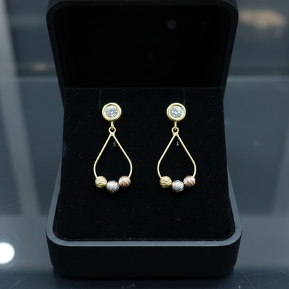 Aretes colgantes tricolor oro 18k en cofre negro